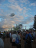 ancat > blimp on a rope with a very expensive camera