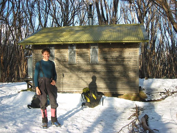 ancat > burnt eucalypts and snow surround the hut at 1400m on the way up the staircase ridge to the summit of mt bogong.